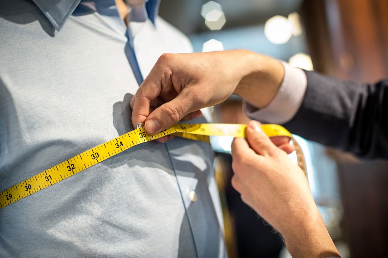Custom dress shirts being measured